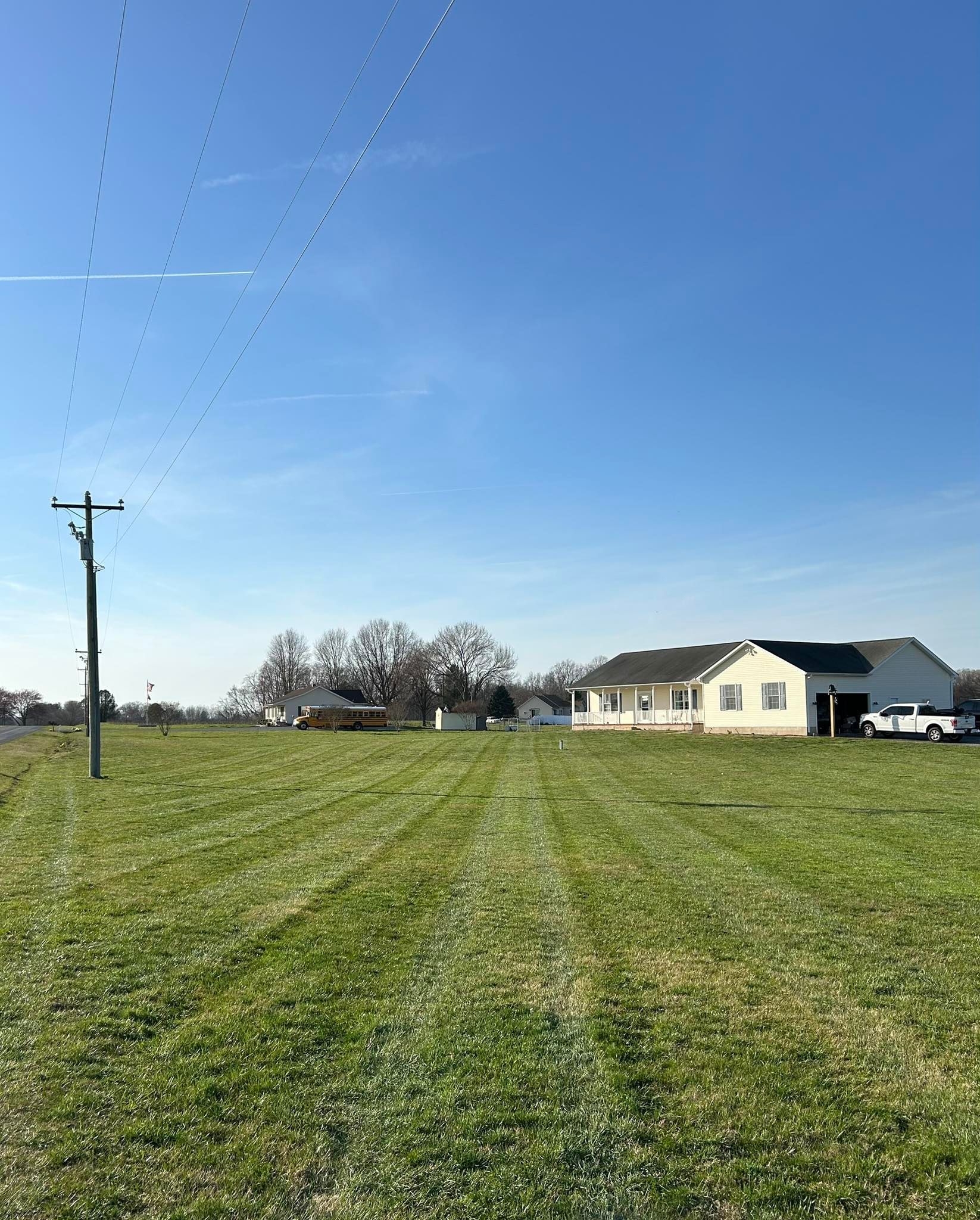 A house is sitting in the middle of a grassy field.