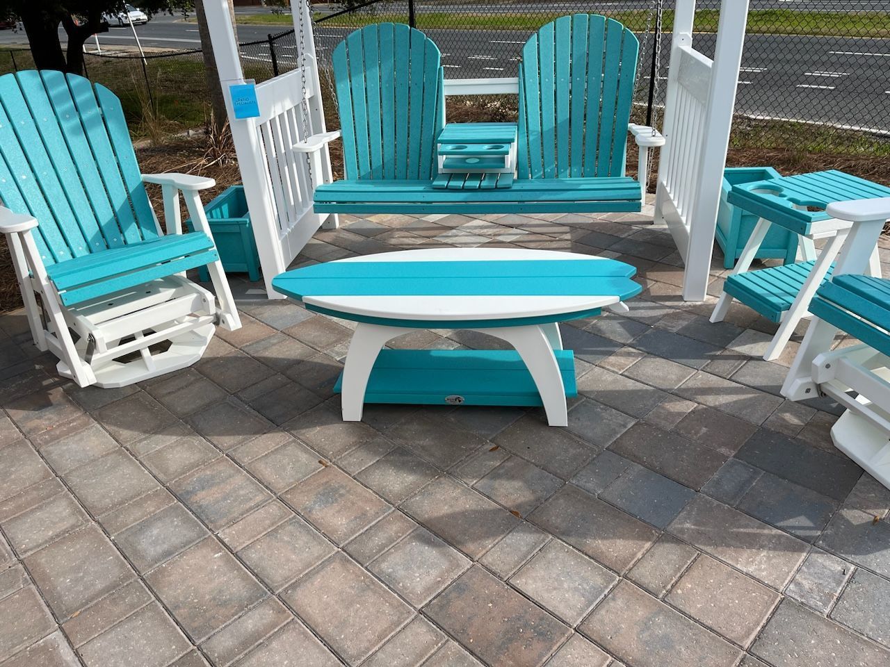 A blue and white patio set with a table, chairs, and a swing.