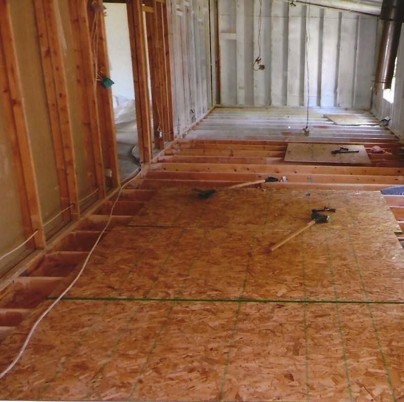 Interior construction; wood framing and plywood flooring. Room under renovation. Tools and wires visible.