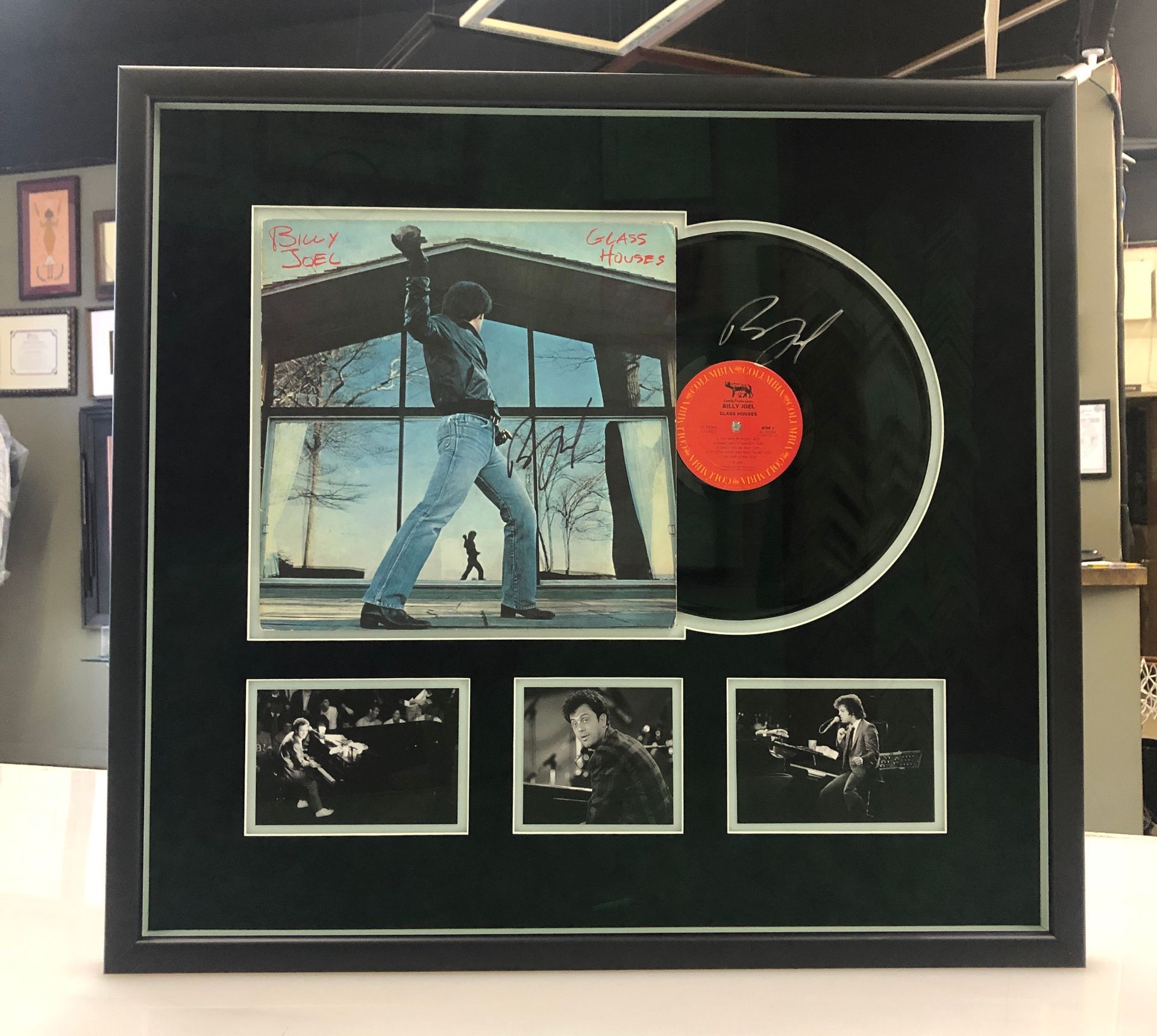 A framed record with a picture of a man holding a guitar