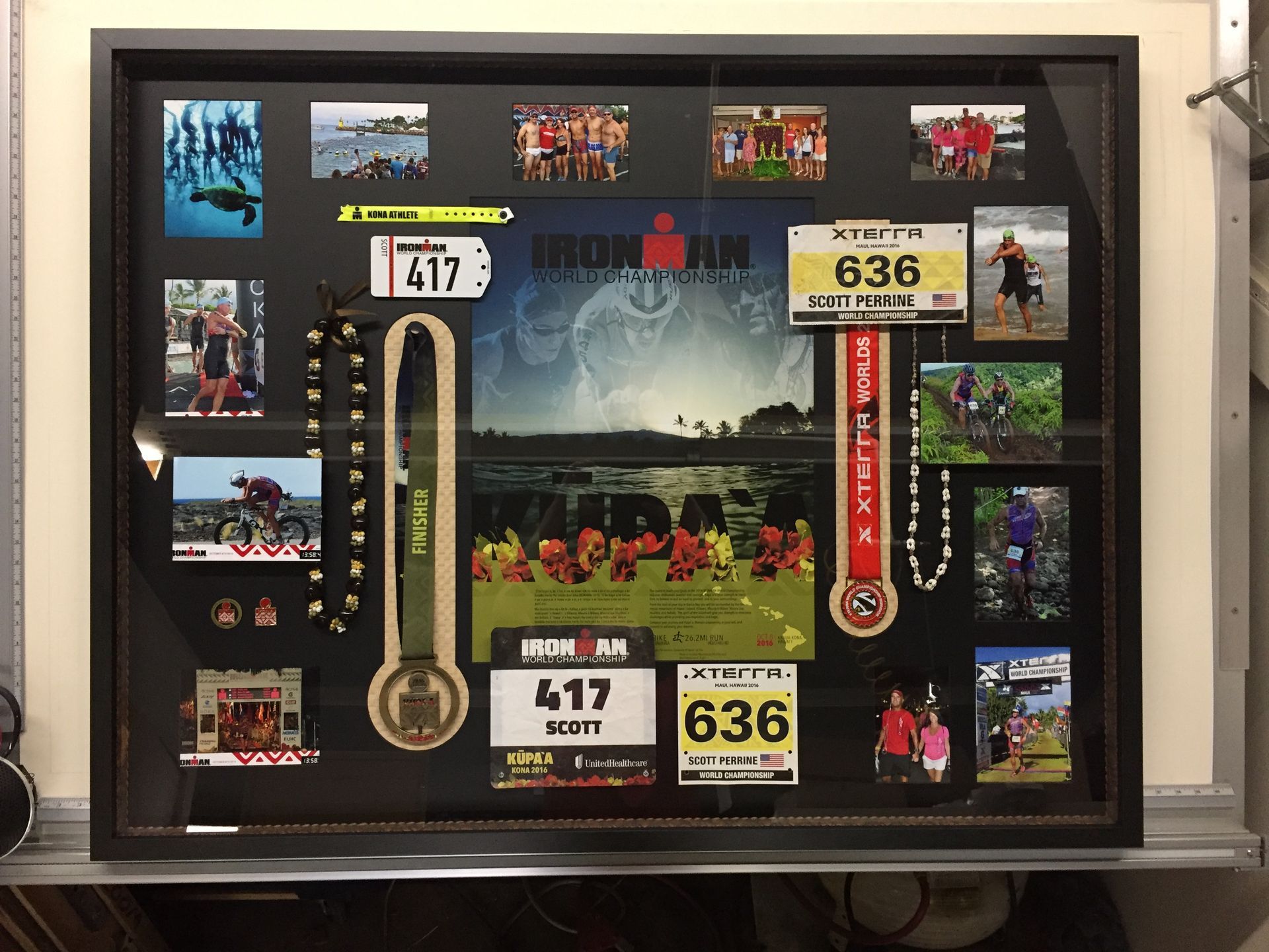 A framed picture of a runner's medals including one that says 417