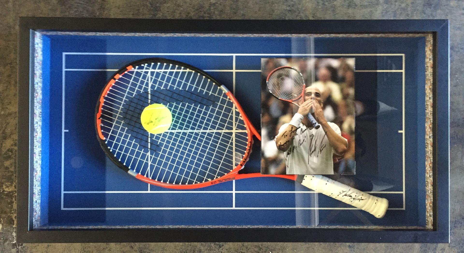 A tennis racket and a tennis ball on a tennis court