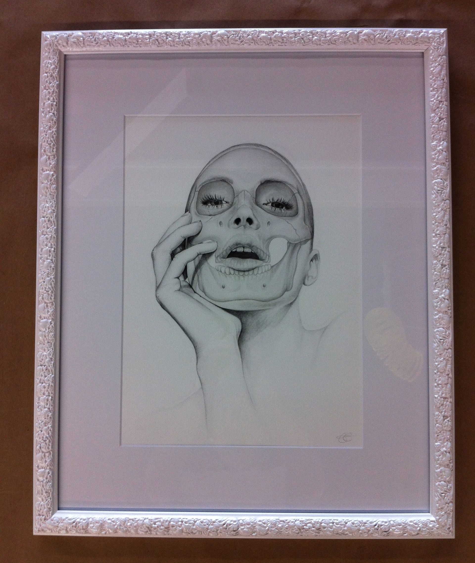 A drawing of a woman's face in a white frame