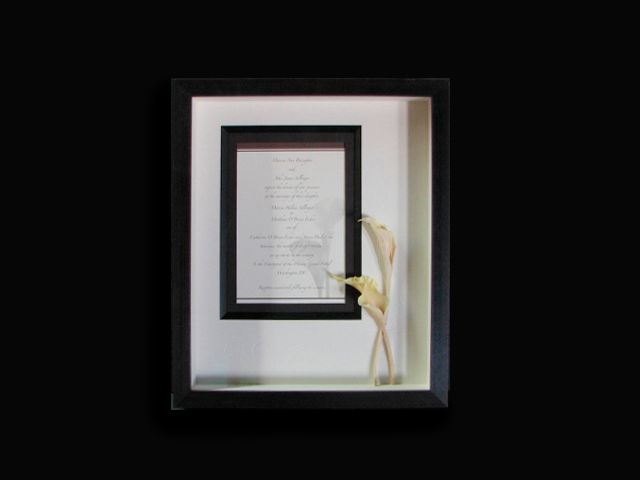 A picture frame with a picture of a flower inside of it.