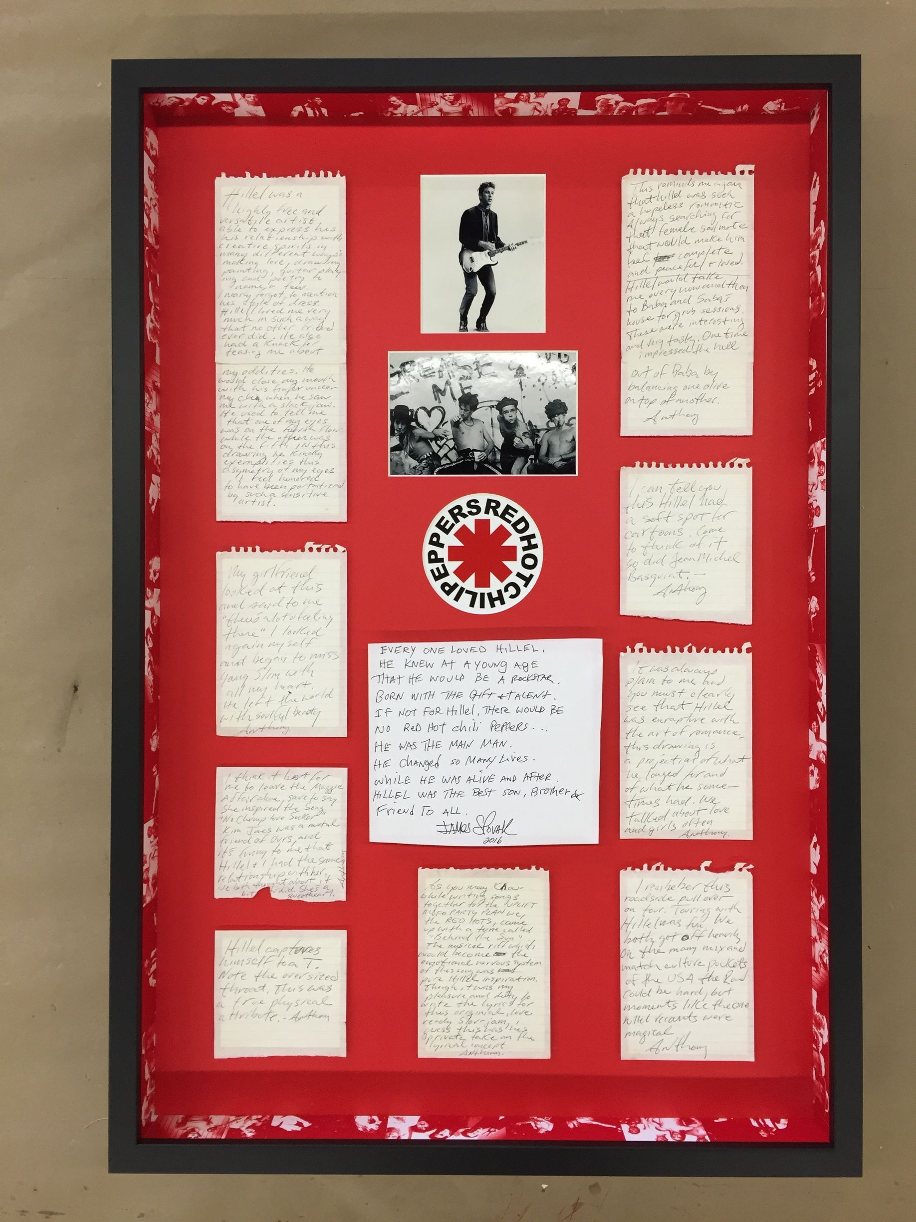A framed display of red hot chili peppers memorabilia