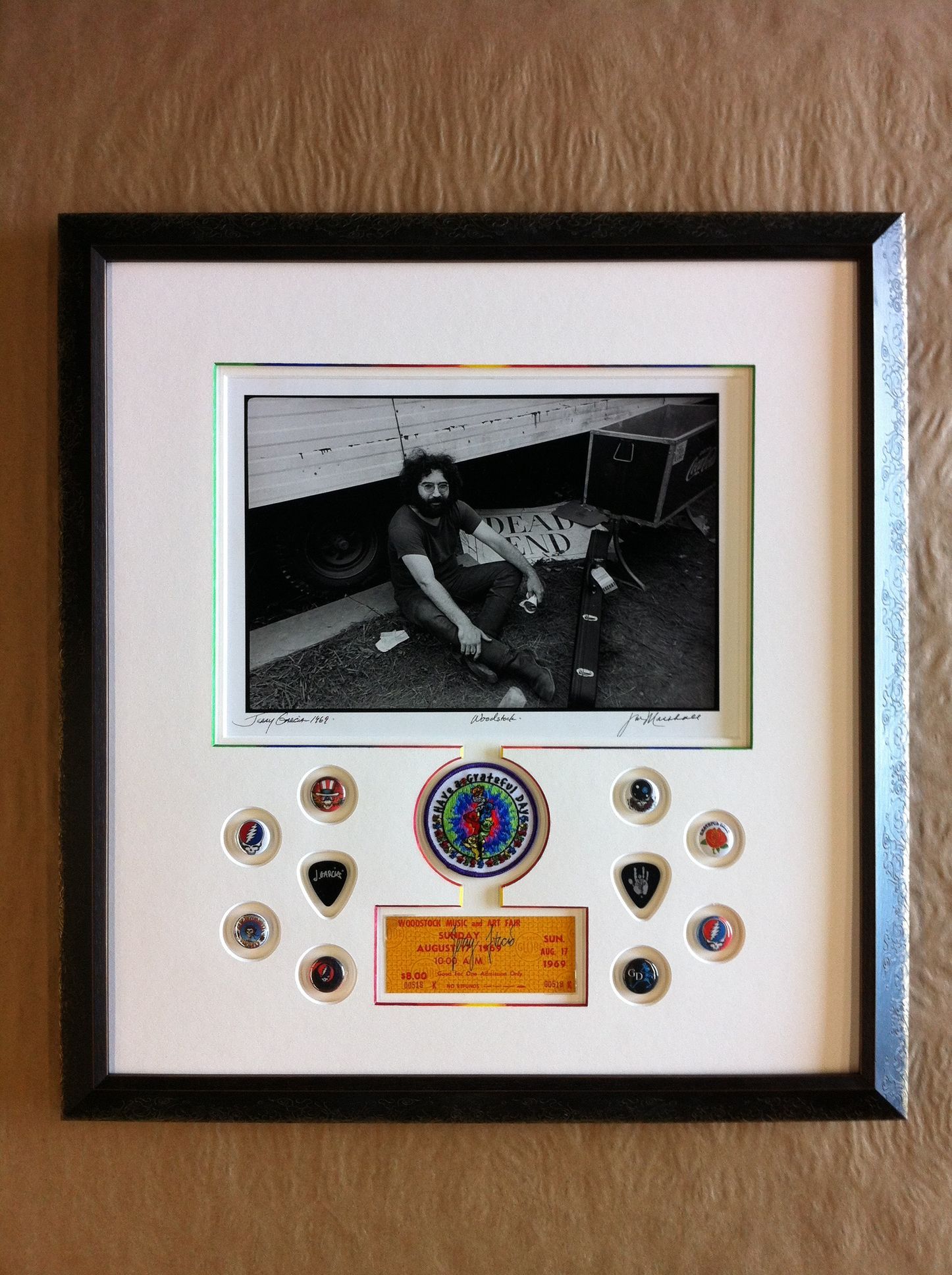 A framed picture of a man sitting on the floor