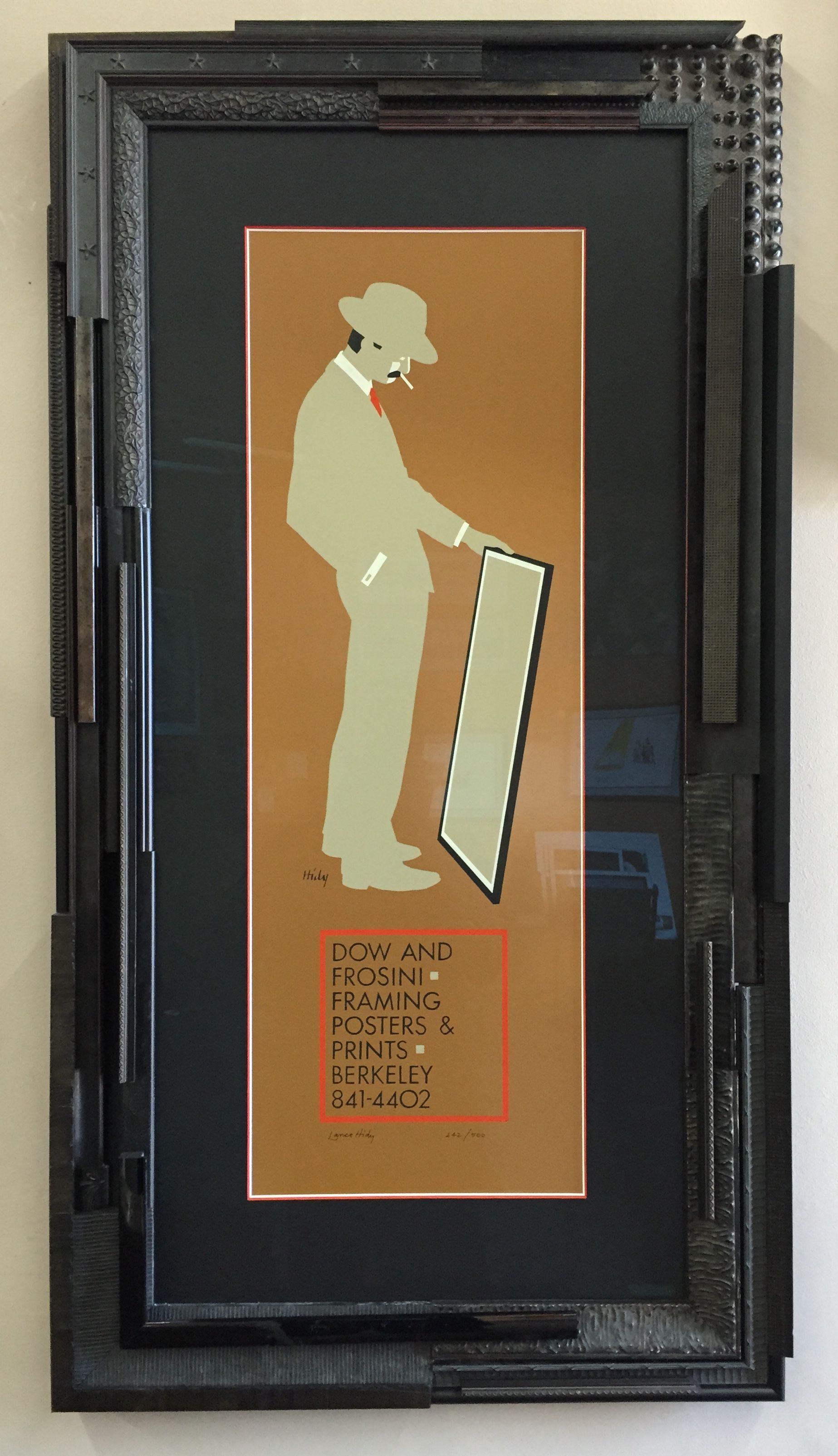 A framed picture of a man holding a mirror