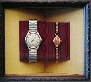 A watch and a bracelet are displayed in a frame