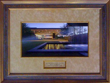 A picture of a house in a gold frame