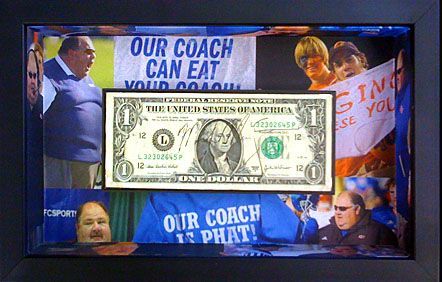 A framed picture of a dollar bill with a sign that says 