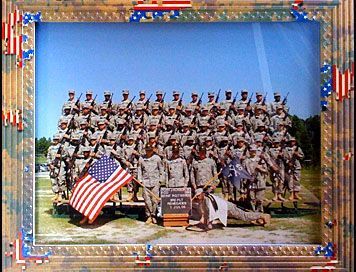 A group of soldiers are posing for a picture with an american flag