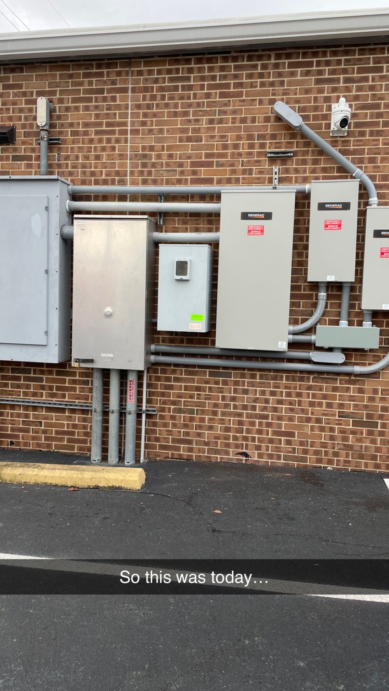 A brick building with a lot of electrical boxes on it.