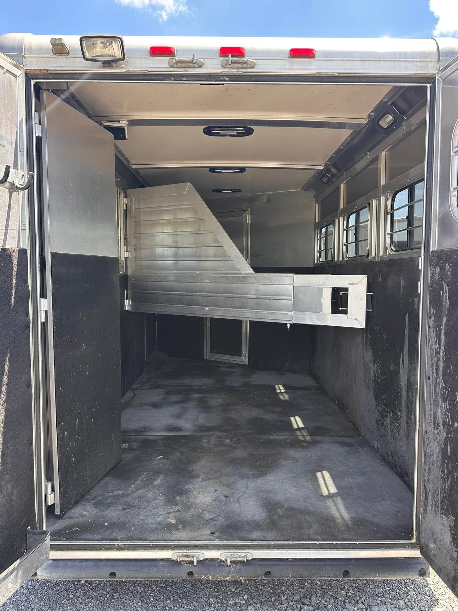 Empty cargo trailer interior with a large metal ramp or equipment partially blocking the space.