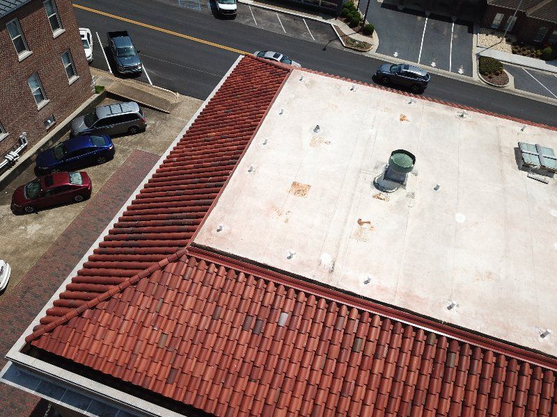 An aerial view of a building with a red tiled roof