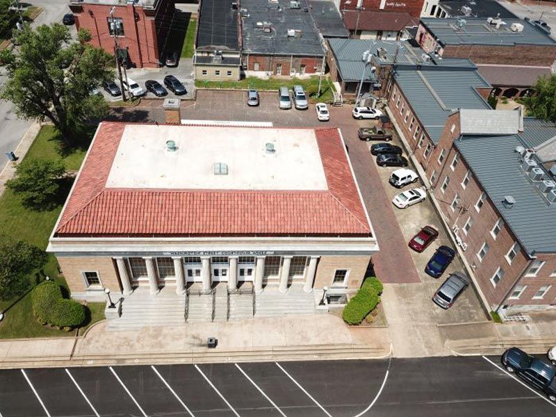 An aerial view of a building with cars parked in front of it
