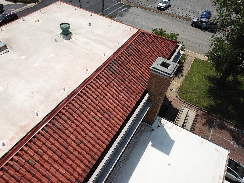 An aerial view of a building with a red tiled roof