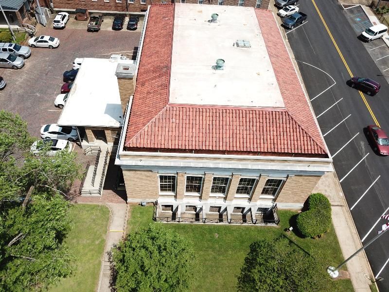 An aerial view of a building with a red tile roof