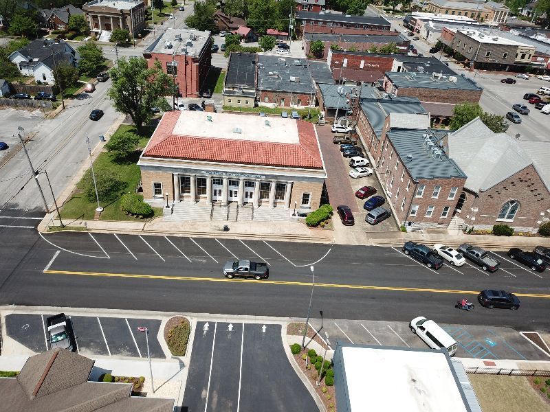 An aerial view of a city with a large building in the middle