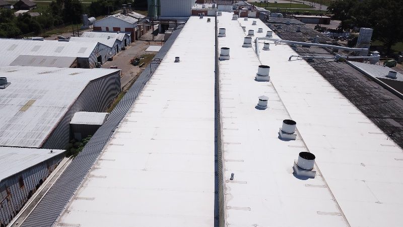 An aerial view of a white roof of a building