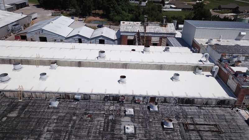 An aerial view of a building with a white roof.