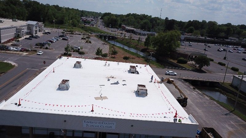 An aerial view of a building with a white roof.