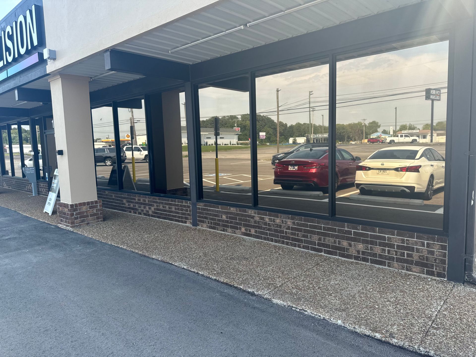 A building with a lot of windows and cars parked in front of it.