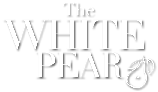 White logo reading “The White Pear” with a stylized pear illustration