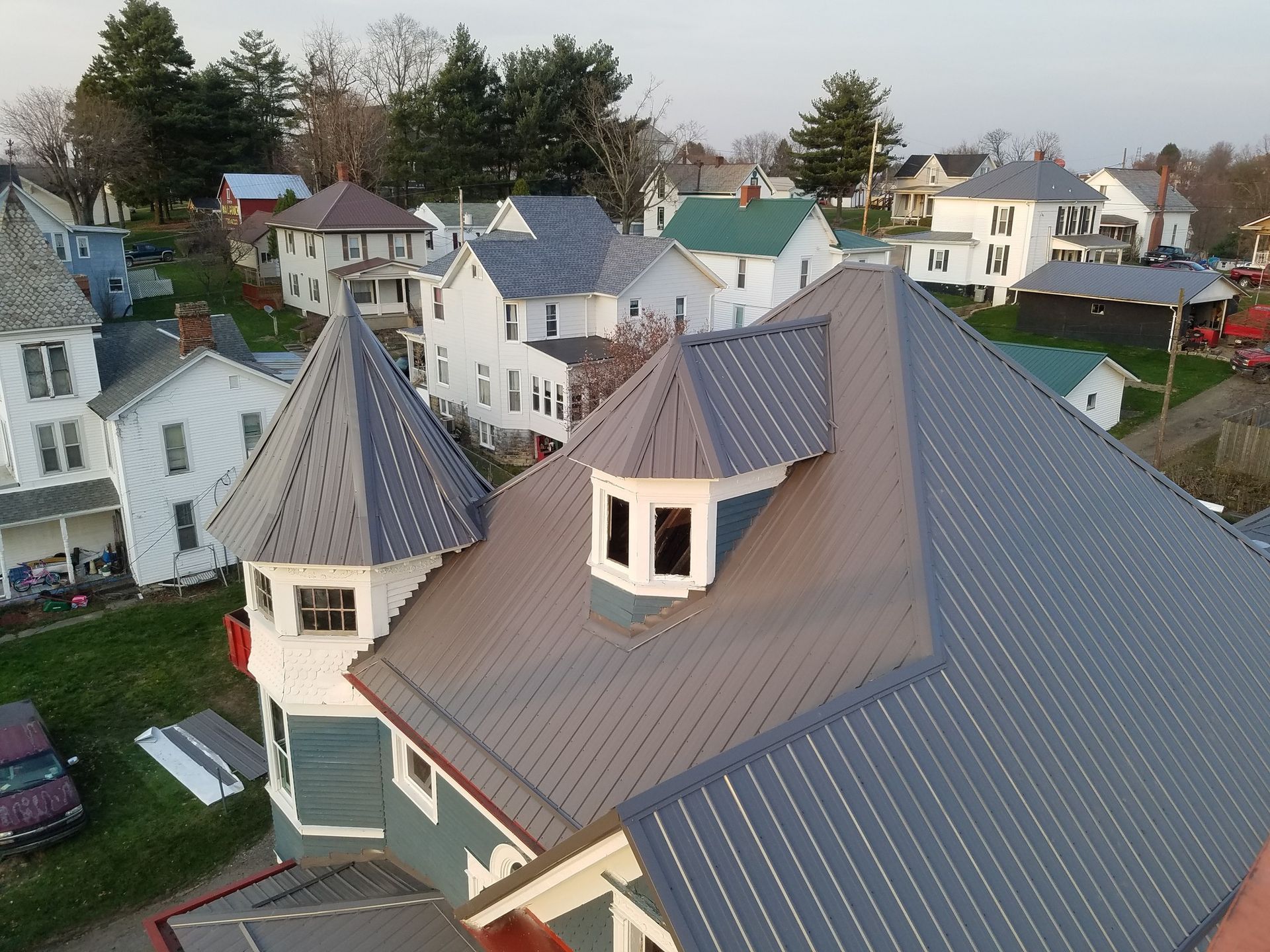 An aerial view of a house with a gray roof
