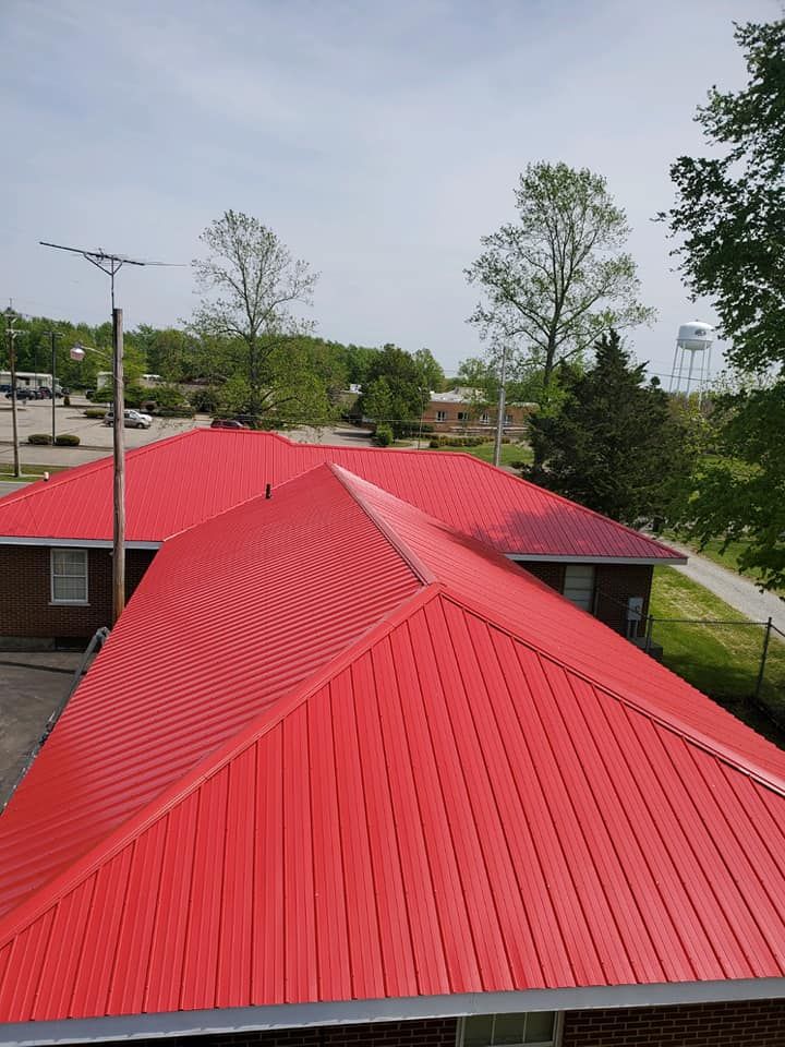 A red roof with a water tower in the background
