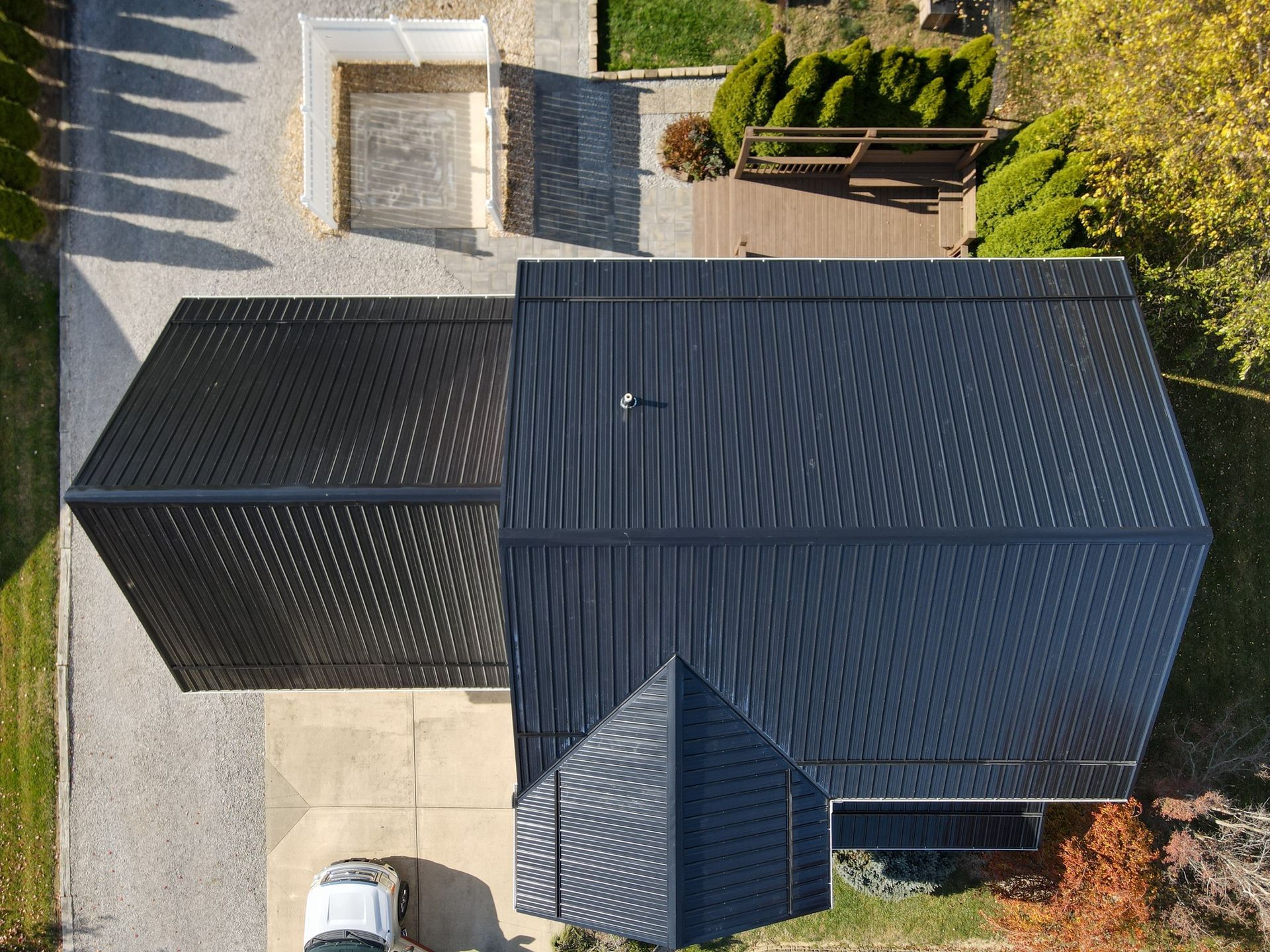 An aerial view of a house with a black roof