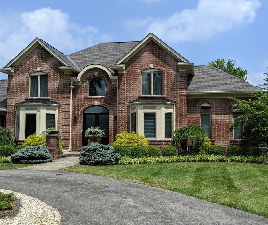 A large brick house with a gray roof