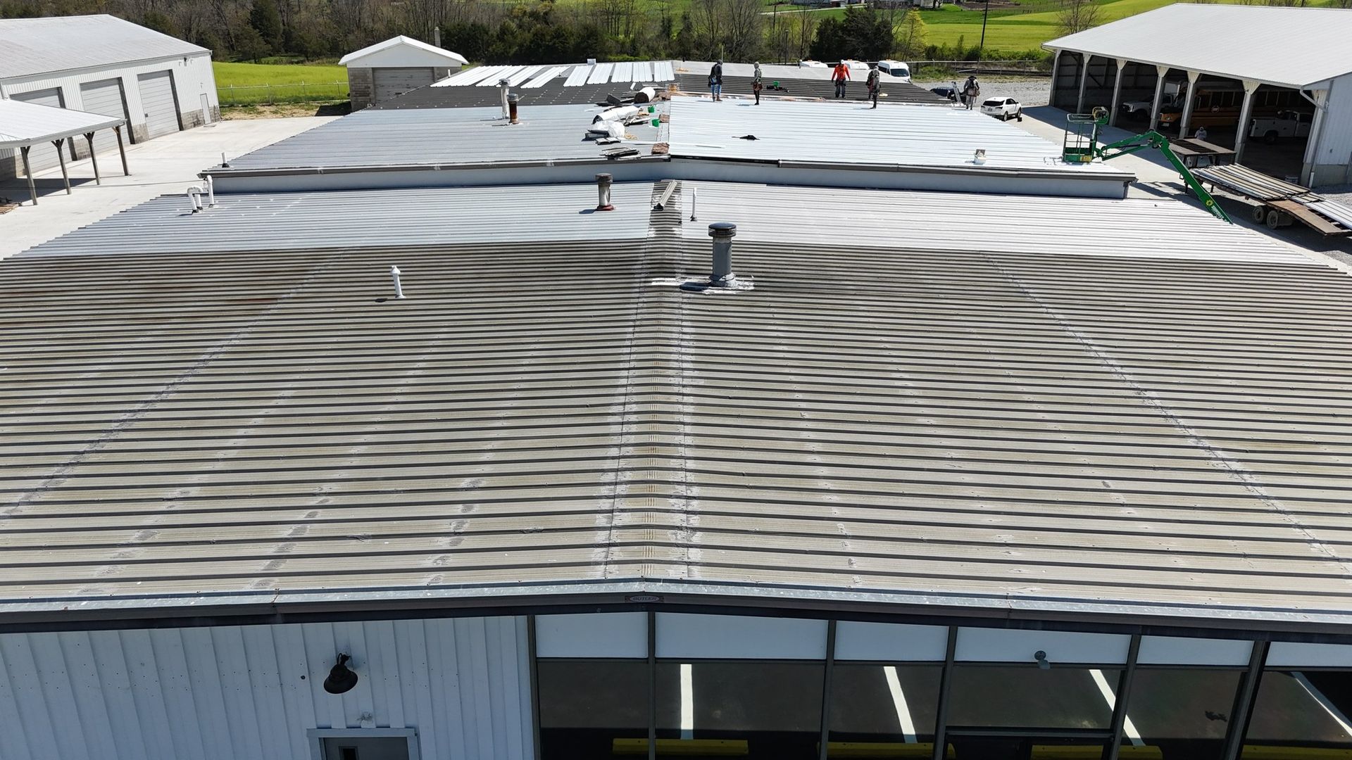 An aerial view of a large building with a circular pattern on the roof.
