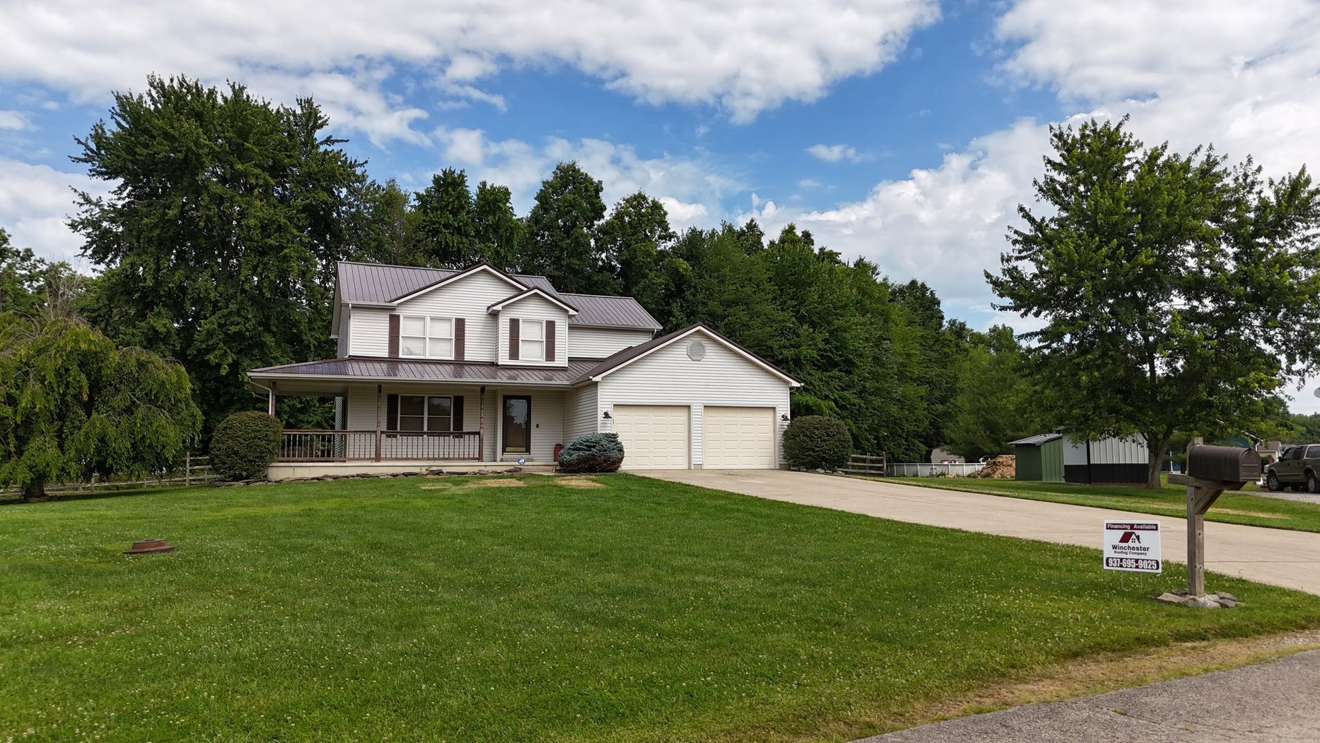 A large white house with a mailbox in front of it