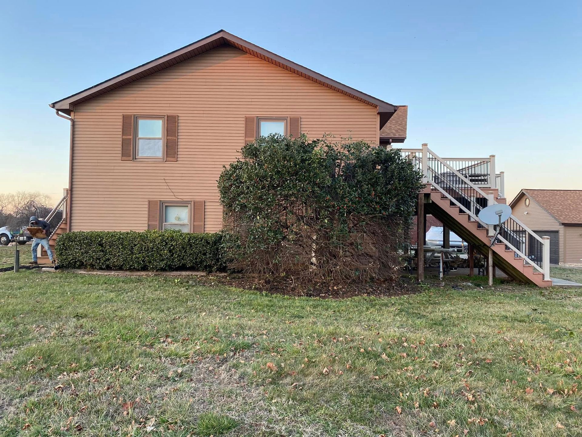 The back of a house with a deck and stairs.