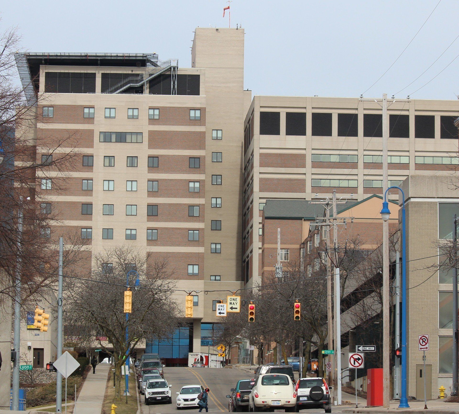 A busy street with a no parking sign in front of a large building