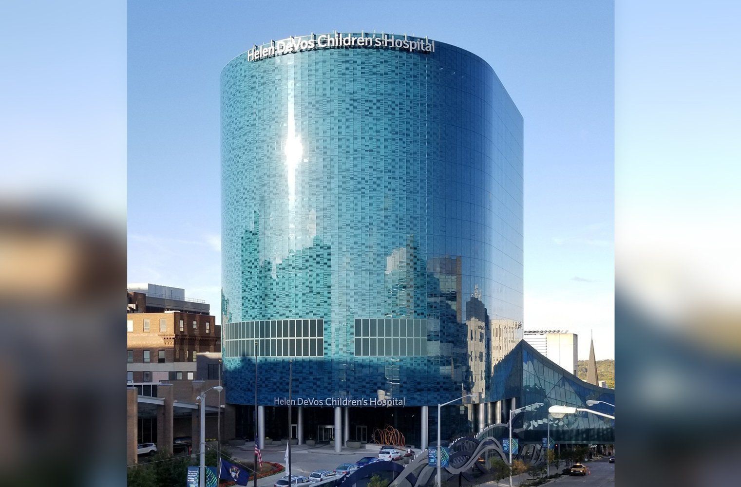 A tall building with a lot of windows and a blue sky in the background.