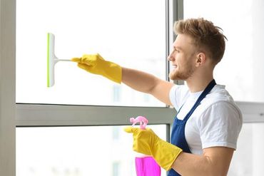 Man cleaning glass with squeegee