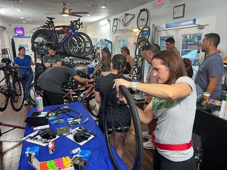 A group of people are working on a bicycle in a bicycle shop.