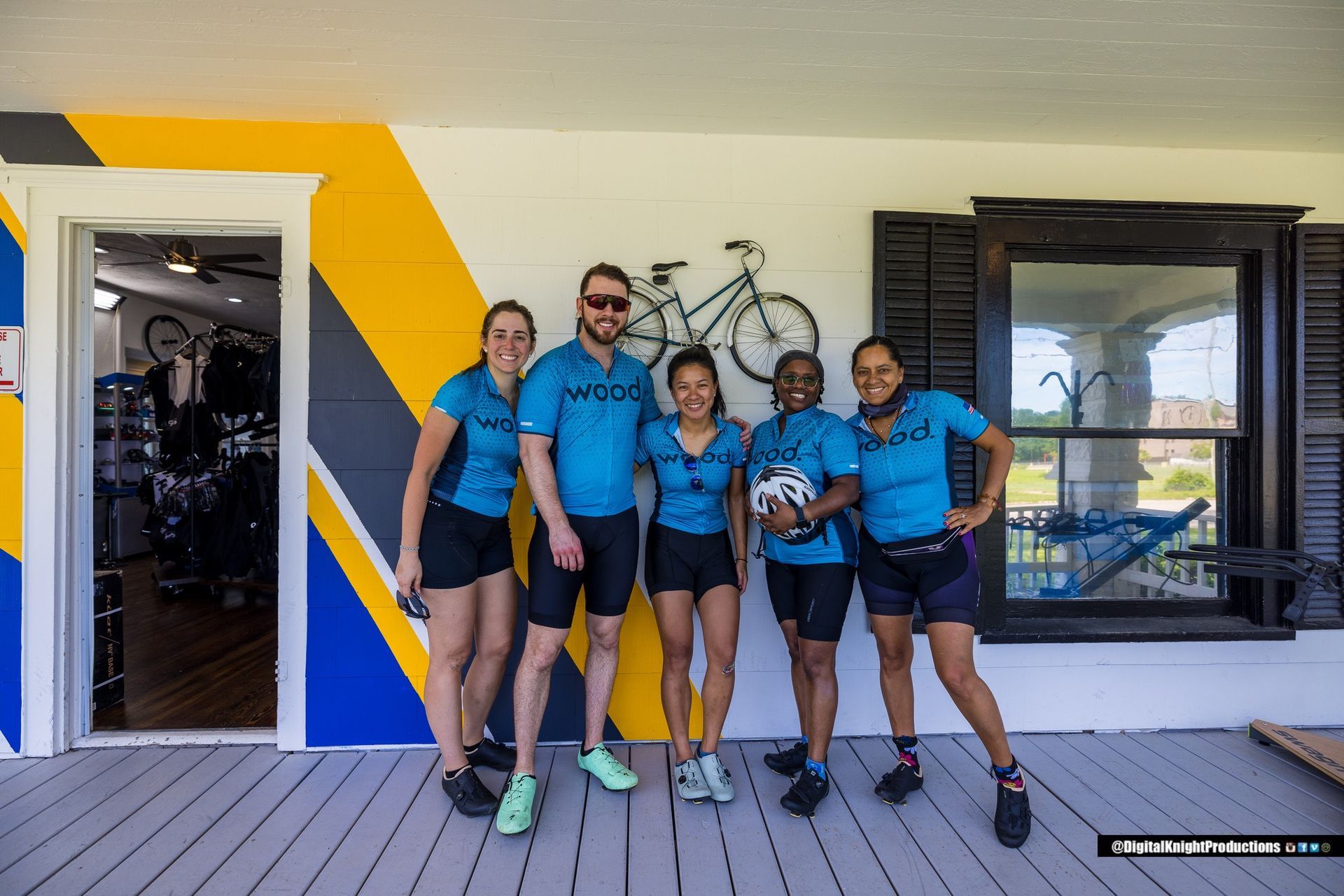 A group of people are posing for a picture in front of a building.