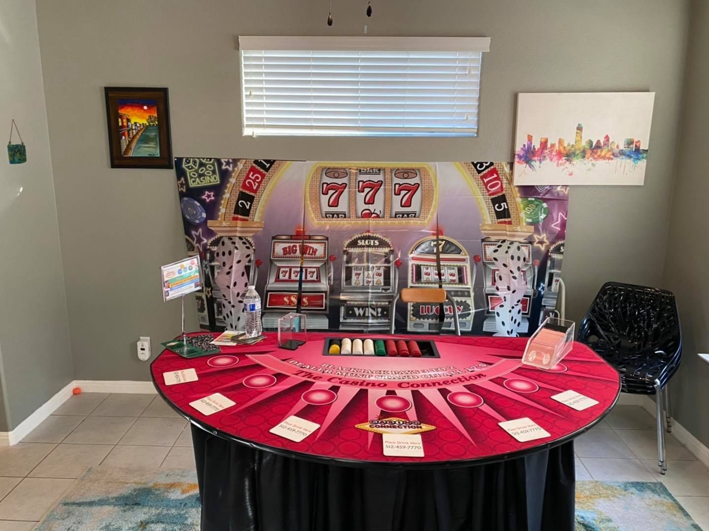 There is a roulette table in the middle of the room.