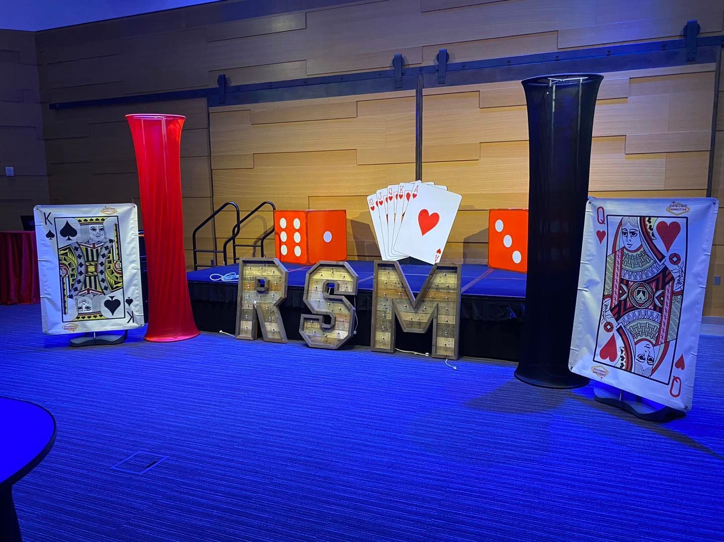 A room decorated with playing cards, dice, and RSM letters.