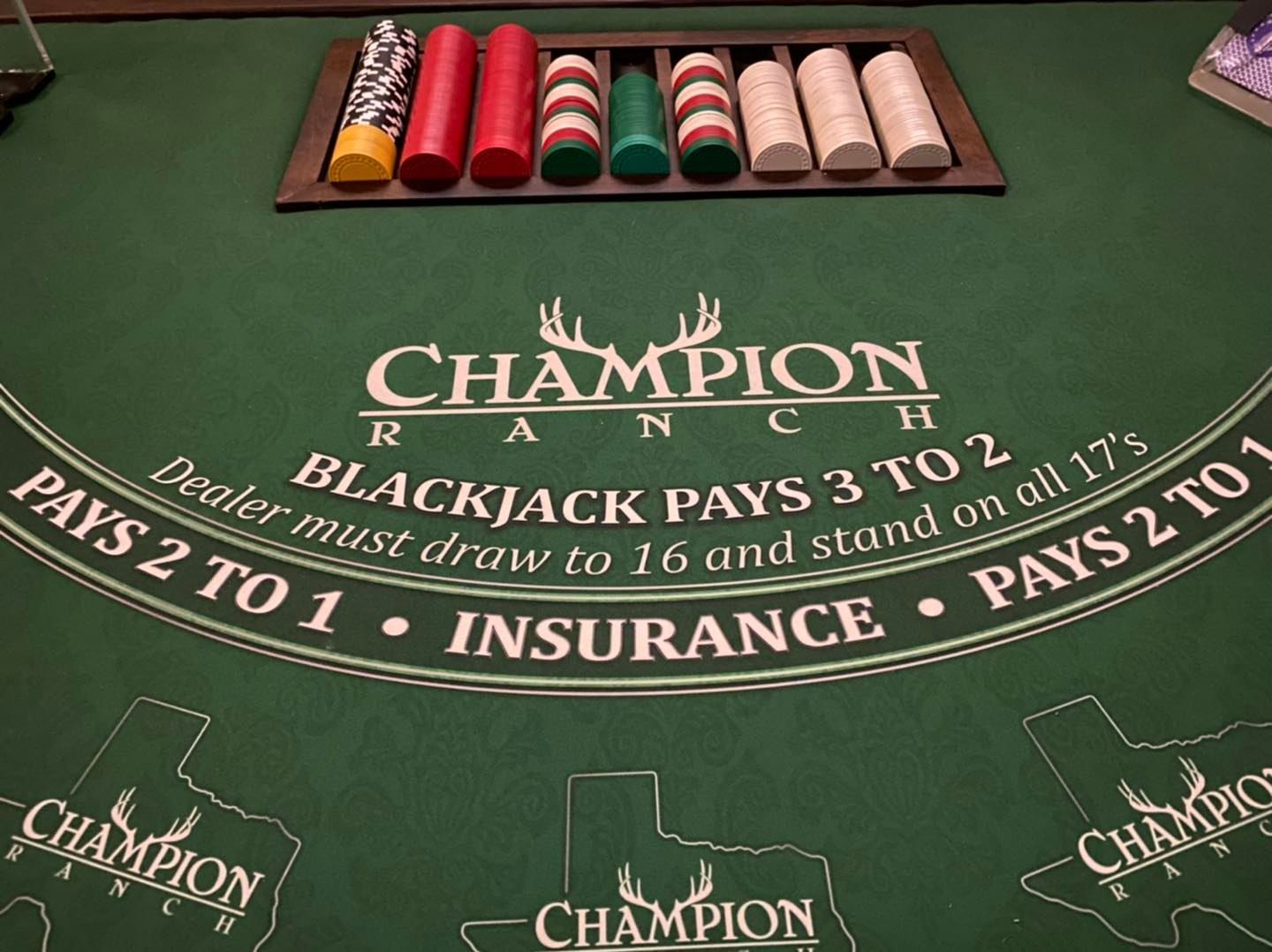 A blackjack table that says champion on it