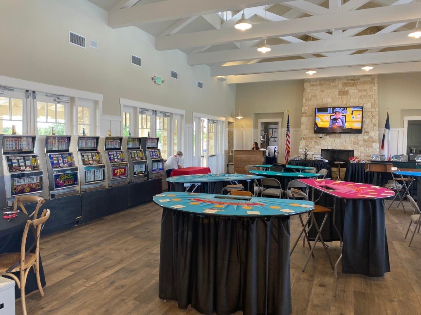 A large room with tables and chairs set up for a party.