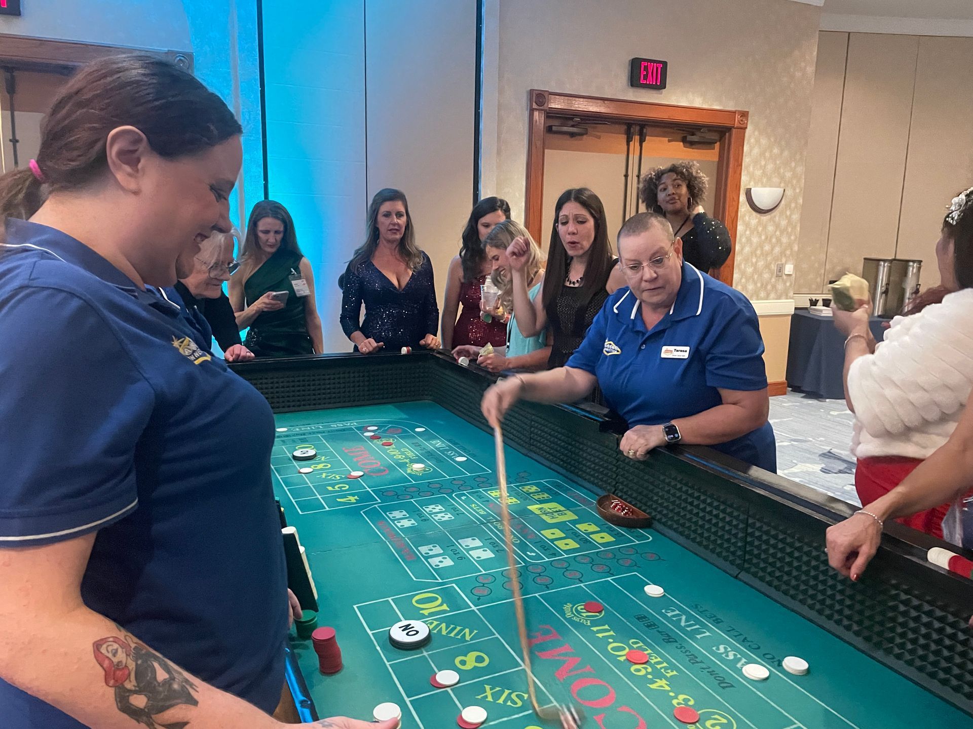 A group of people are playing a game of craps in a casino.