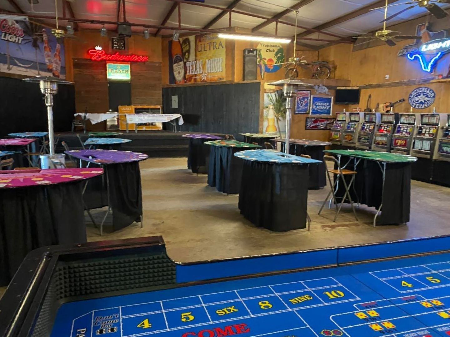 There is a roulette table in the middle of the room.