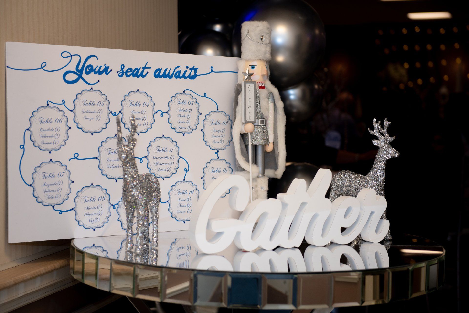 A seating chart with a festive display: white sign,