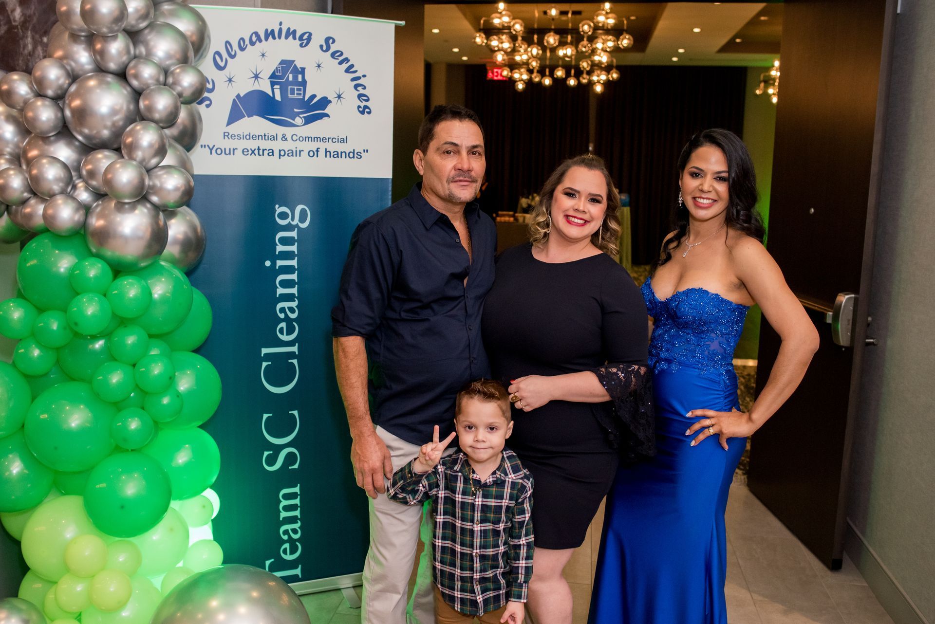 Family poses at an event with balloons and a