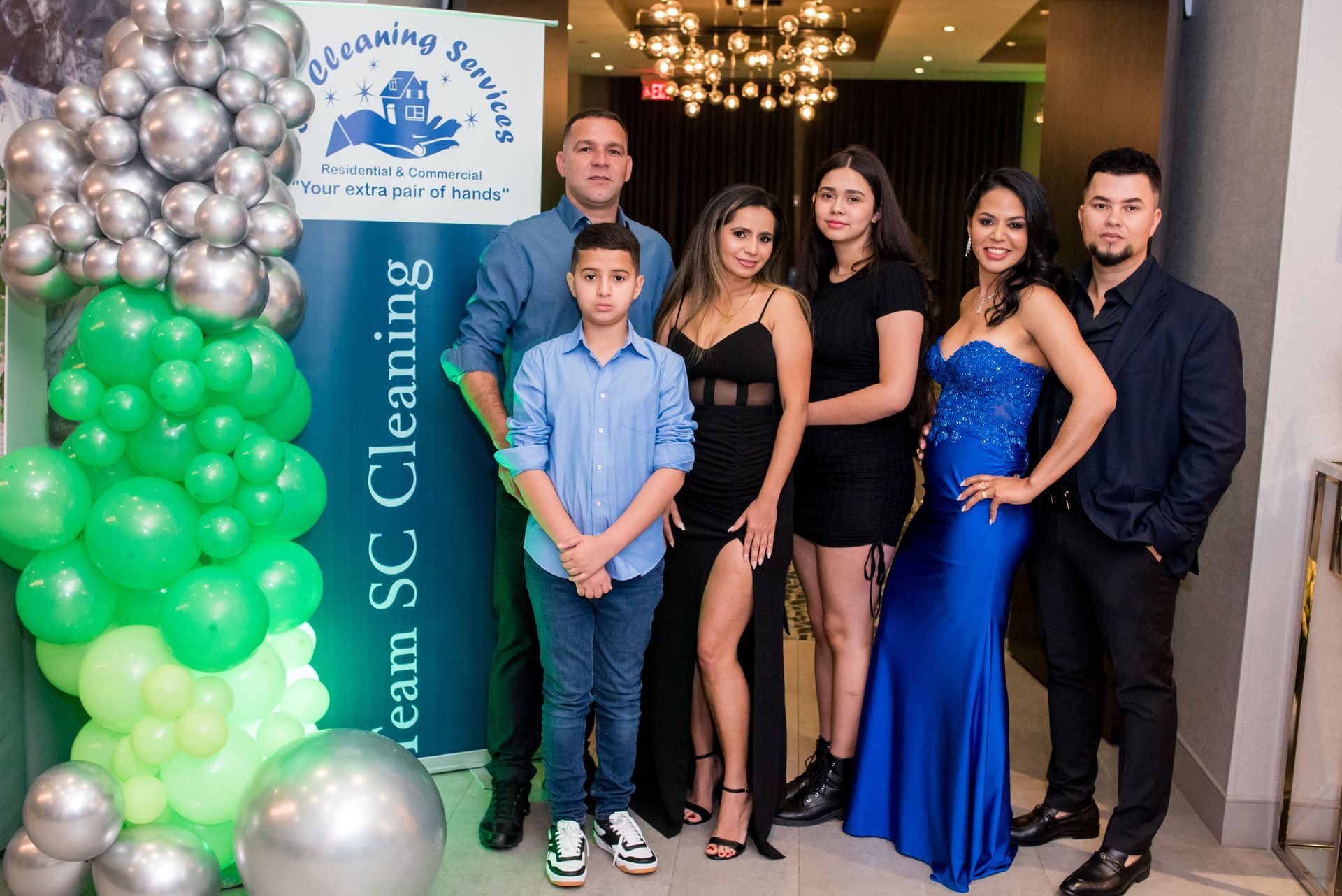 Family posing in front of a banner for