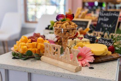 Charcuterie board with nuts, cheese, fruit, and wooden