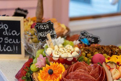 Charcuterie board with fresh mozzarella, grapes, and salami.